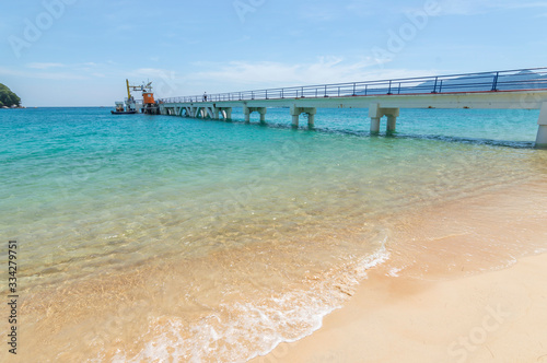 Jetty with clear water and blue skies