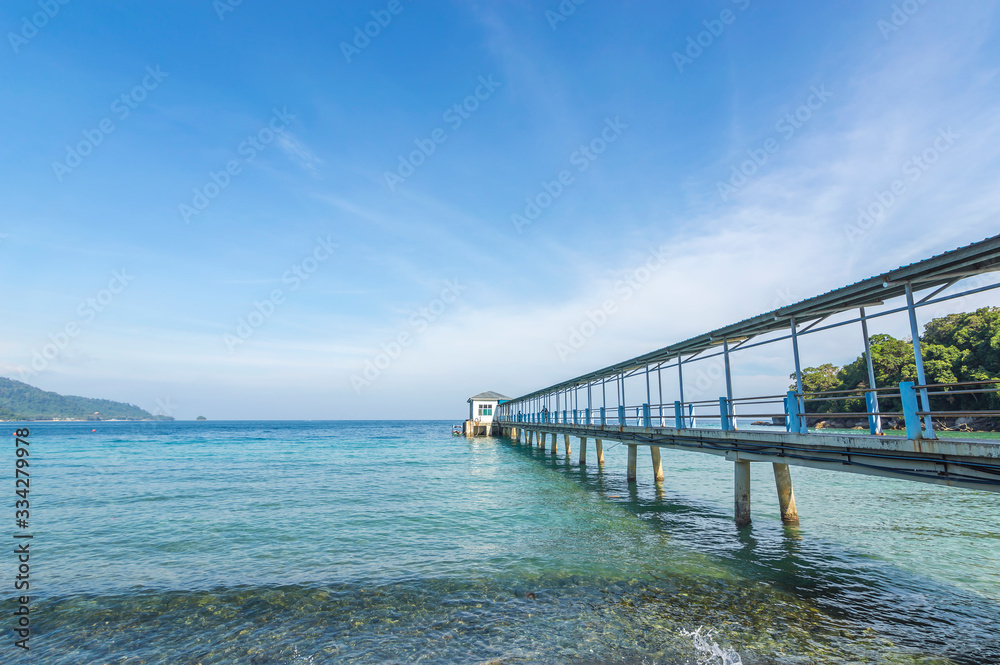 Jetty with clear water and blue skies