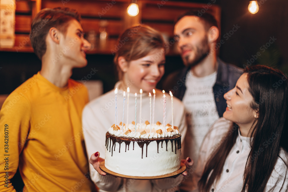 Young people congratulating a pretty woman with birthday at home Young people congratulating a pretty woman with birthday at home