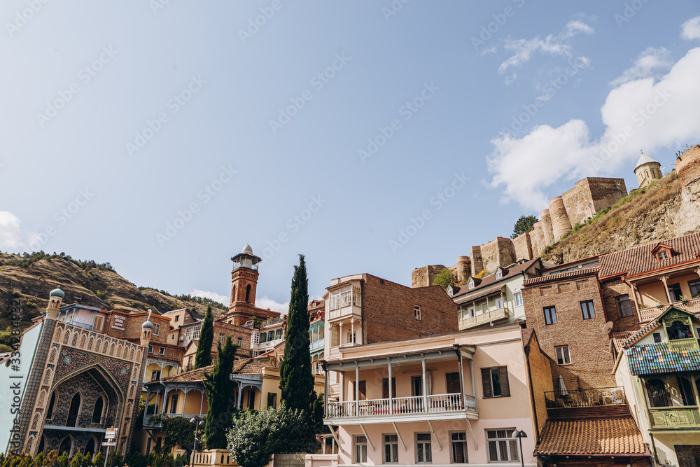 01.06.2019 Tbilisi, Georgia: view of old stone houses with beautiful colored roofs in the center of the old town where tourists are walking