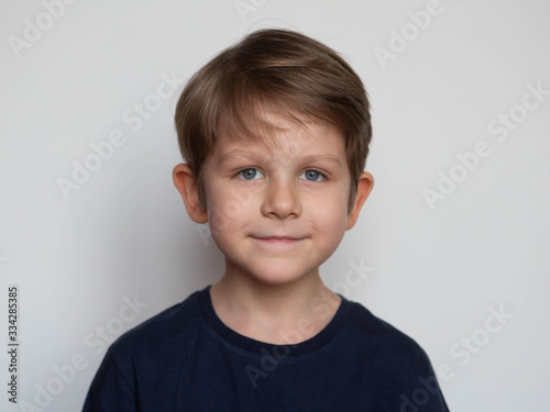 Portrait of a cute smiling preschooler boy on white background