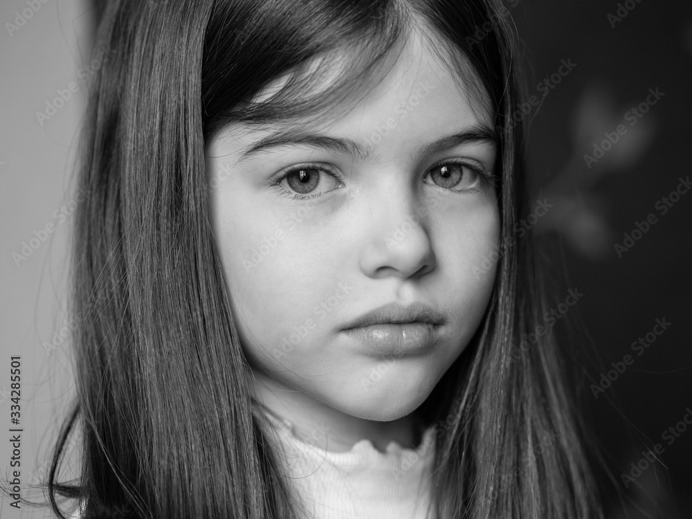 portrait of a little / young sad brunette girl, black and white photo portrait of a little / young sad brunette girl, black and white photo
