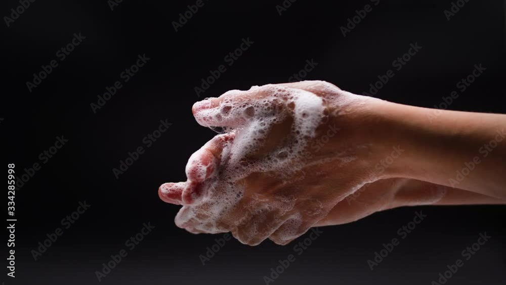 Woman washes his hands with liquid soap in a bathroom. Corona Virus idea. Extreme close up
