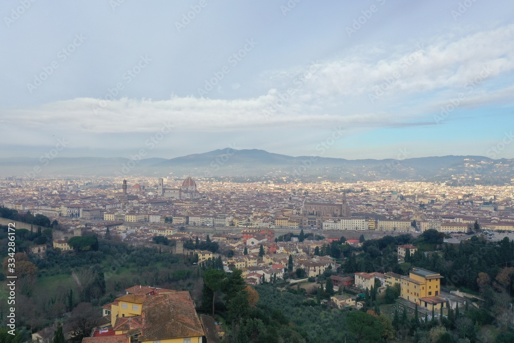 Aerial panorama of Florence at sunrise, Firenze, Tuscany, Italy, cathedral, river, drone pint view, mountains is on background
