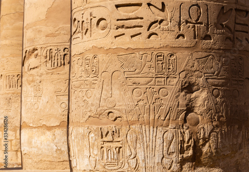 Karnak Temple, complex of Amun-Re. Great Hypostyle Hall. Embossed hieroglyphics on columns. Luxor Governorate, Egypt.