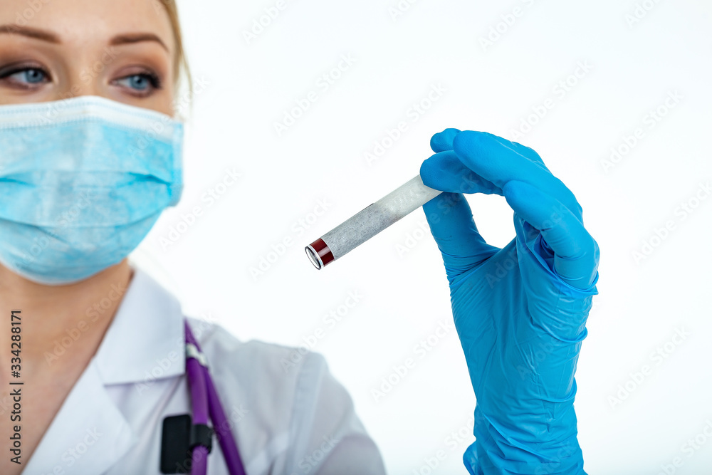 Doctor's hand in a medical glove holds a test tube with a place for inscription. Coronavirus drug search concept. Place for text. Isolated on a white background Doctor's hand in a medical glove holds a test tube with a place for inscription. Coronavirus drug search concept. Place for text. Isolated on a white background