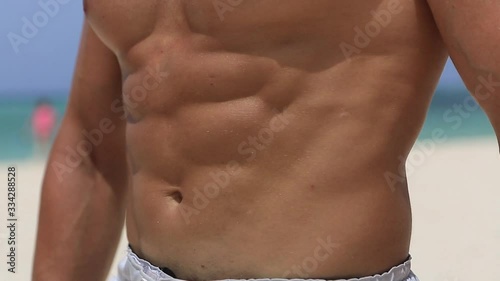 a man shows his beautiful abs