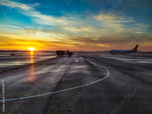 Φωτογραφία Fuel tanker on airstrip at the sunrise
