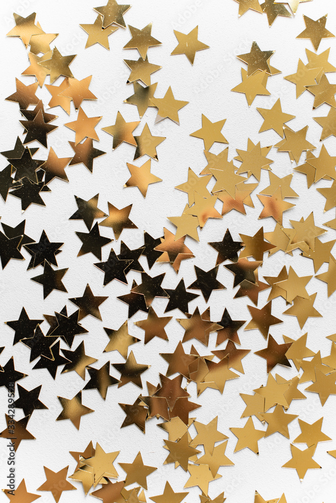 Greeting card with sequins for the inscription, gold spangles in the shape of stars, top view, white background, copy space, flat lay Greeting card with sequins for the inscription, gold spangles in the shape of stars, top view, white background, copy space, flat lay