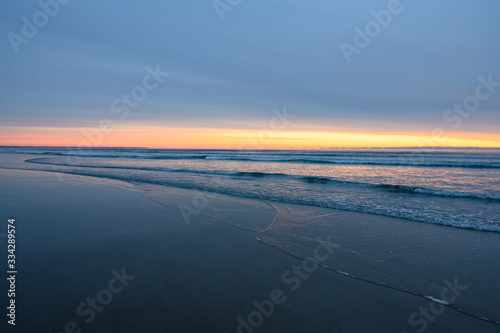 Sunrise over ocean with calm waves