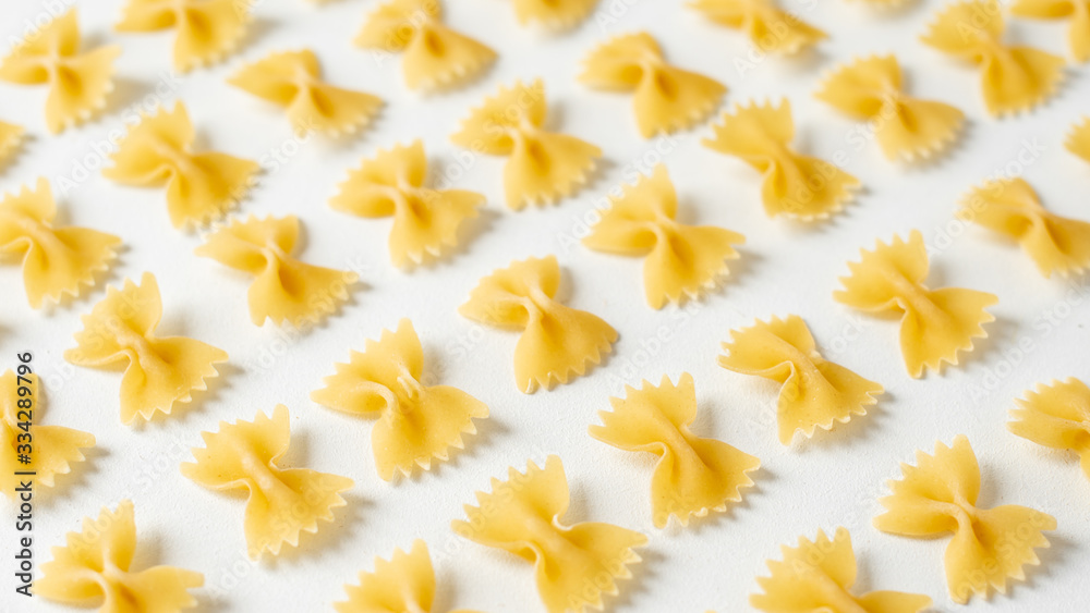 Pasta, durum wheat pasta in the form of bows, food pattern, top view, copy space flat lay Pasta, durum wheat pasta in the form of bows, food pattern, top view, copy space flat lay