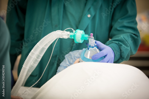 Oxygen mask ventilator is put on a patient prior to surgery anesthesia