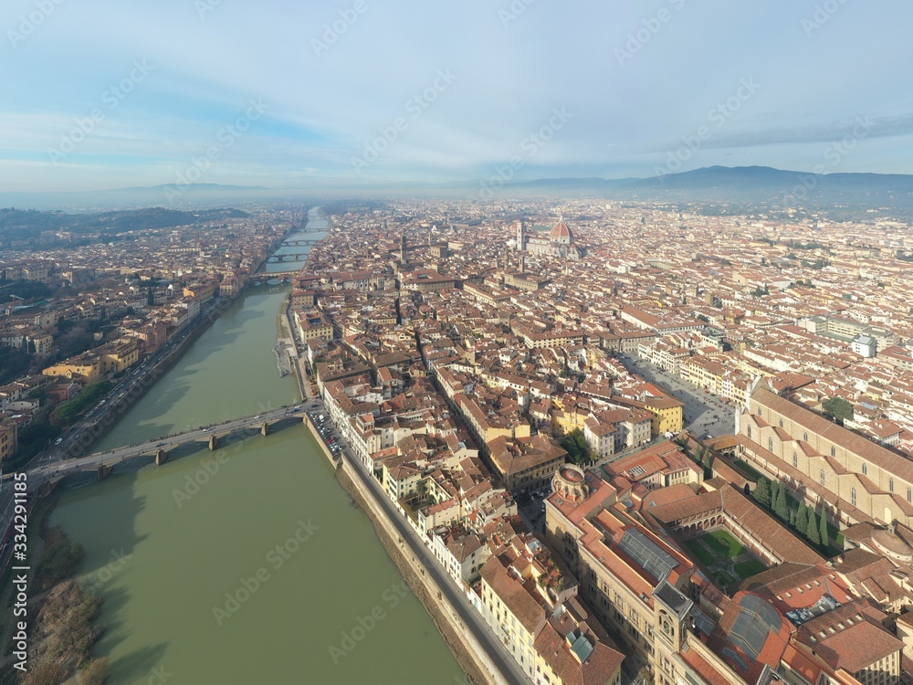 Obraz premium Aerial panorama of Florence at sunrise, Firenze, Tuscany, Italy, cathedral, river, drone pint view, mountains is on background