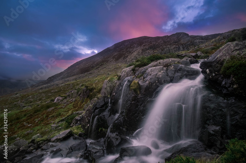 Snowdonia National Park sunrise, waterfall cascades with views of Afon Lloer - Snowdonia National Park, Wales.