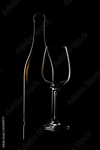 Bottiglia con bicchiere su sfondo nero