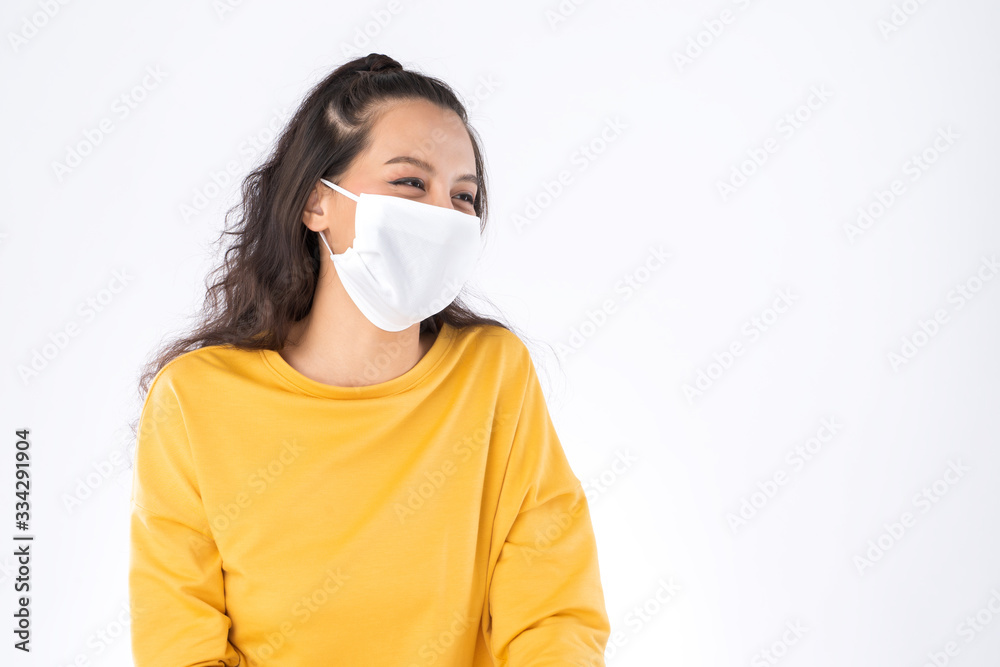 Young happy Asian woman wearing hygienic mask to prevent infection corona virus Air pollution pm2.5 she wearing a yellow sweater shoot in shot isolated on white background Young happy Asian woman wearing hygienic mask to prevent infection corona virus Air pollution pm2.5 she wearing a yellow sweater shoot in shot isolated on white background