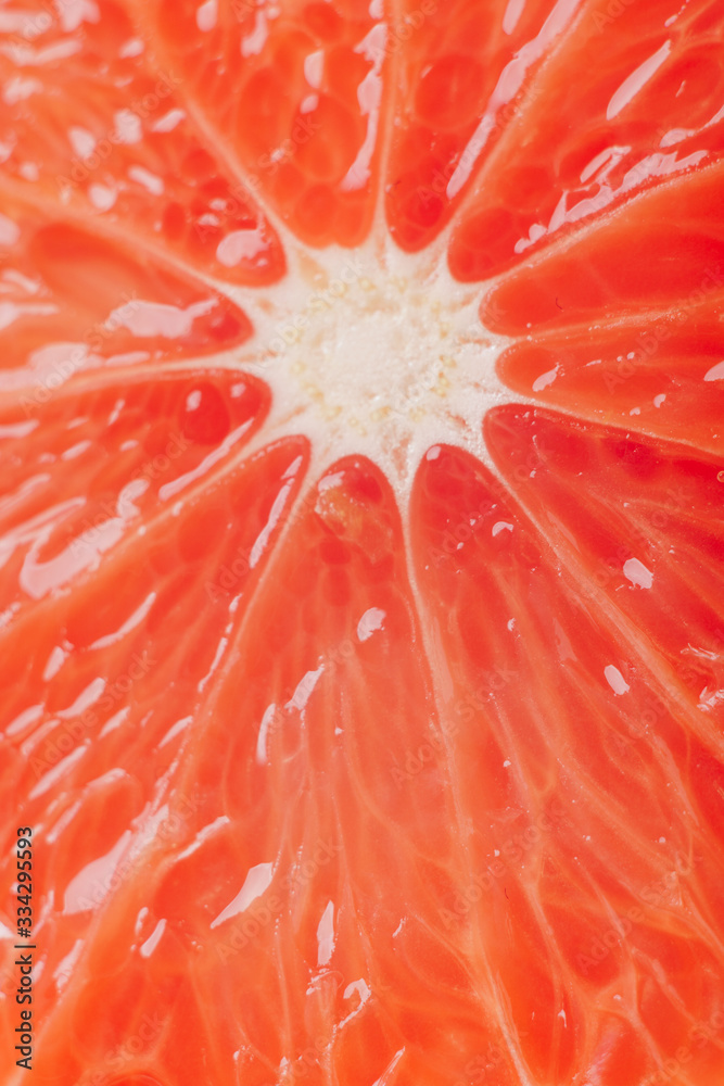 juicy fresh ripe grapefruit in a section close-up, macro juicy fresh ripe grapefruit in a section close-up, macro