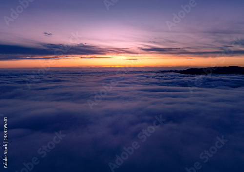 Above the clouds at sunset