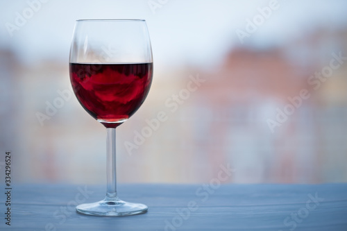 A glass of red wine near the window