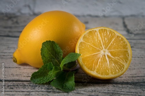 Lemons and mint leaves on a wooden talbe