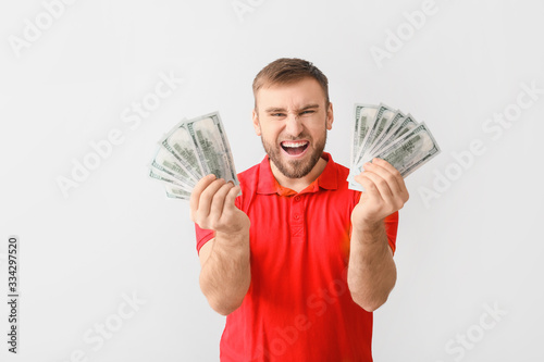 Happy young man with money ...