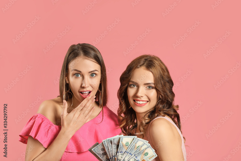 Happy young women with money on color background Happy young women with money on color background