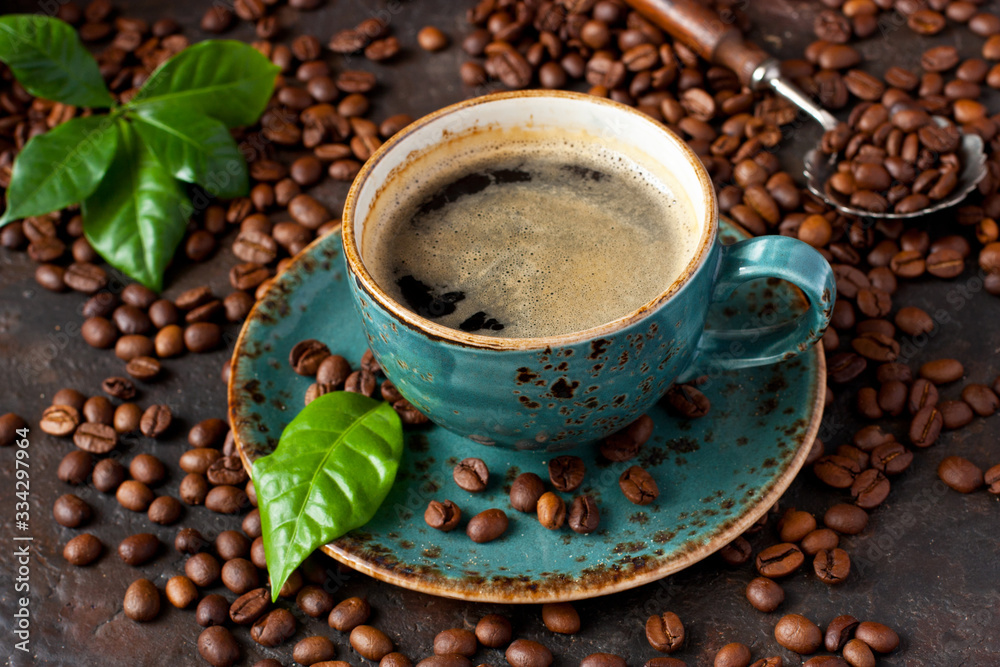 Coffee cup and coffee beans on wooden background Coffee cup and coffee beans on wooden background