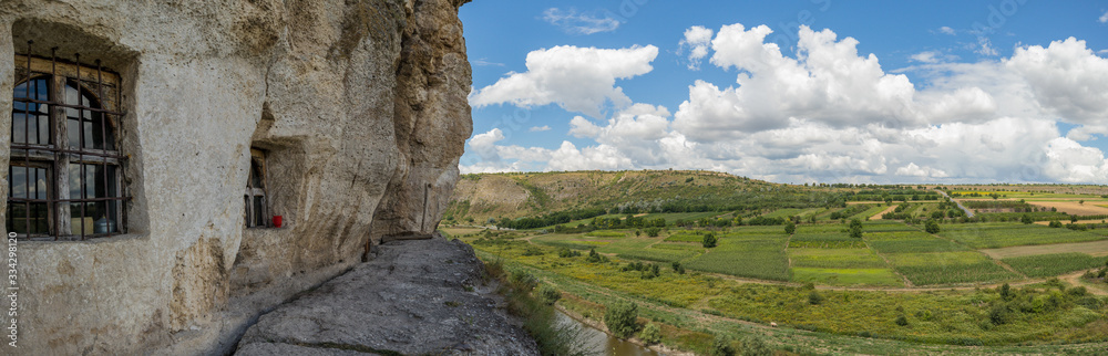 Beautiful landscape of rocks and trees at Orheiul Vechi monastery in Moldova on a sunny summer day. View from one of the historic cave monasteries.