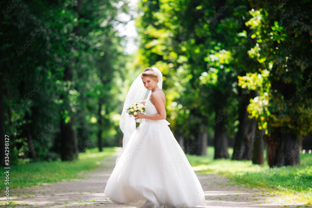 beautiful blonde bride enjoys her wedding day in the summer