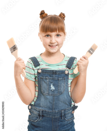 Little girl with paint brus...