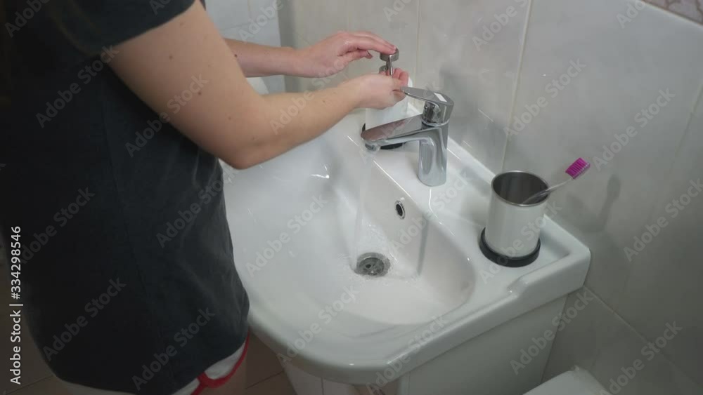 Woman washes her hands thoroughly, uses liquid soap for disinfection in COVID-19. Hygiene in coronavirus quarantine, hand disinfection to kill germs. Woman washes her hands thoroughly, uses liquid soap for disinfection in COVID-19. Hygiene in coronavirus quarantine, hand disinfection to kill germs.