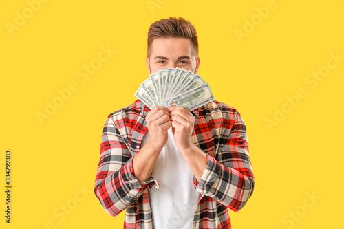 Happy man with money on col...