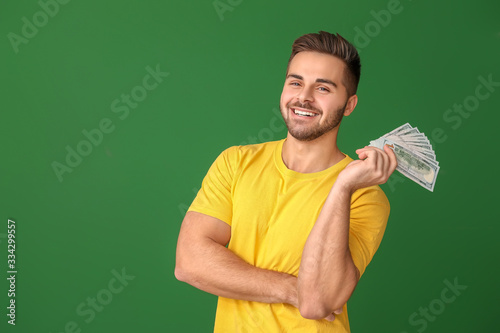 Happy man with money on col...