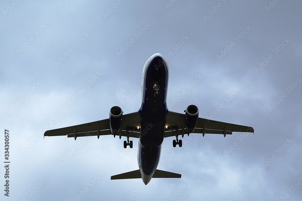 Plane approaching with against dark clouds