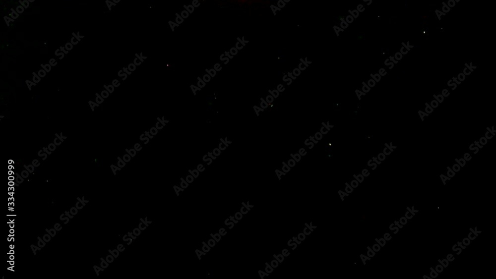 Natural organic sparkle particles on black background. Glittering Particles With Bokeh. Slow motion. Natural organic sparkle particles on black background. Glittering Particles With Bokeh. Slow motion.