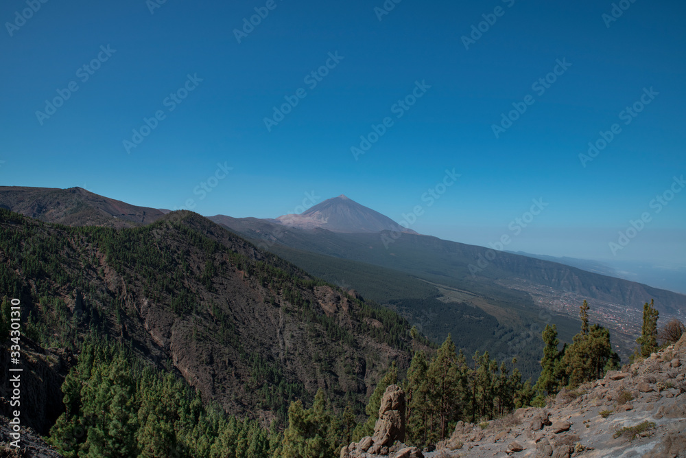 Mount Teide or Pico del Teide, the highest mountain in Spain, as seen from a viewpoint in the National Park, on TF-24 road heading up from the eastern part of the island, in Tenerife, Canary Islands