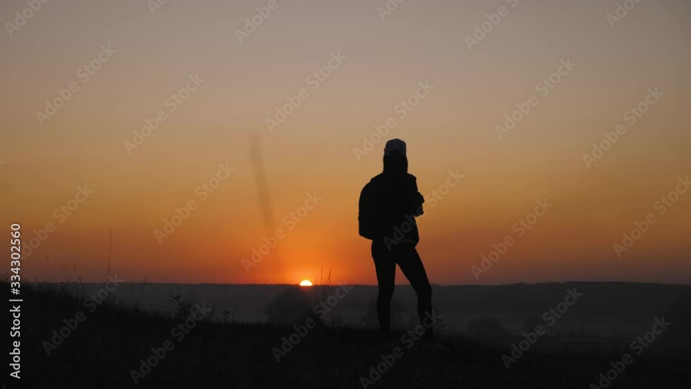 Silhouette girl traveler with backpack hiking in mountains at sunset. Silhouette hiker walking, freedom and happiness concept. Silhouette girl traveler with backpack hiking in mountains at sunset. Silhouette hiker walking, freedom and happiness concept.