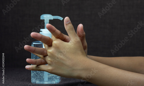 Child girl uses hand sanitizer to clean her hand. Concepts of Flu virus, Covid-19 (Coronavirus disease). Can used for microbiology concept or medical healthcare.