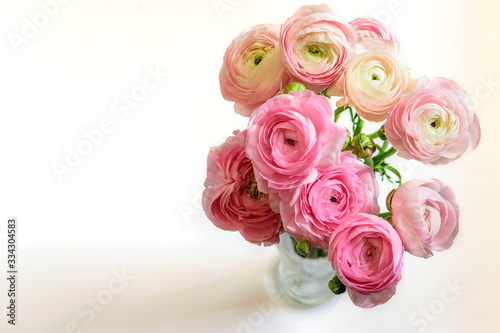 Bouquet of ranunculus in glass vase closeup. Ranunculus asiaticus or Buttercup persian. Ranunculus of peach gelado blossom. Nice bouquet for Mother's Day or Women's Day or St. Valentine's Day.
