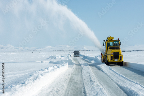 Snow plough removes fresh snow from the road