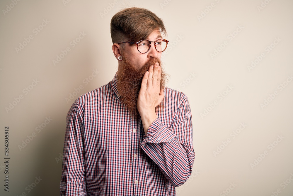 Handsome Irish redhead business man with beard wearing glasses over isolated background bored yawning tired covering mouth with hand. Restless and sleepiness. Handsome Irish redhead business man with beard wearing glasses over isolated background bored yawning tired covering mouth with hand. Restless and sleepiness.