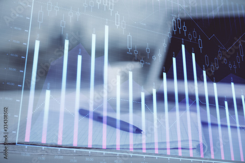 Double exposure of financial graph drawings and desk with open notebook background. Concept of forex market © peshkova