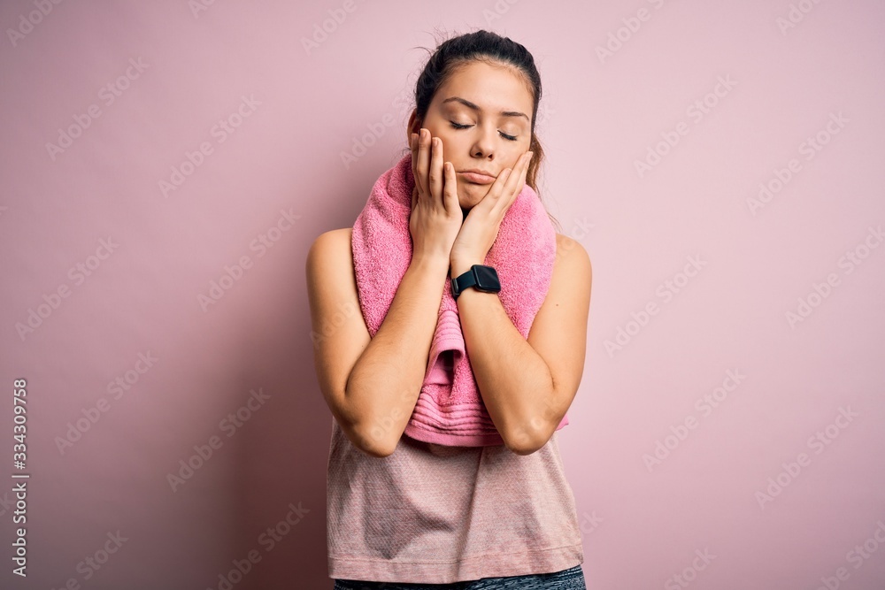 Young beautiful brunette sportswoman wearing sportswear and towel over pink background Tired hands covering face, depression and sadness, upset and irritated for problem Young beautiful brunette sportswoman wearing sportswear and towel over pink background Tired hands covering face, depression and sadness, upset and irritated for problem
