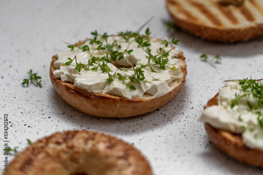 A bagel with cream cheese and microgreen A bagel with cream cheese and microgreen