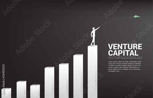 silhouette of businessman throw out money banknote origami paper airplane from stack graph. Business Concept of start business and entrepreneur