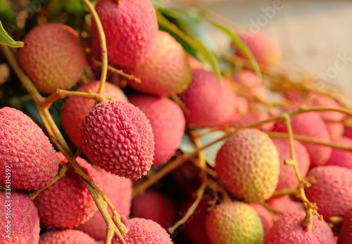 pink ripe lychee on wooden floor.