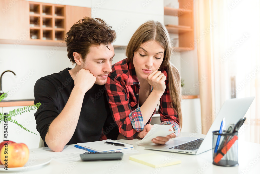 Couple calculating money. Home budget concept Couple calculating money. Home budget concept