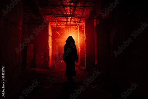 Принти на полотні Creepy silhouette in the dark red illuminated abandoned building
