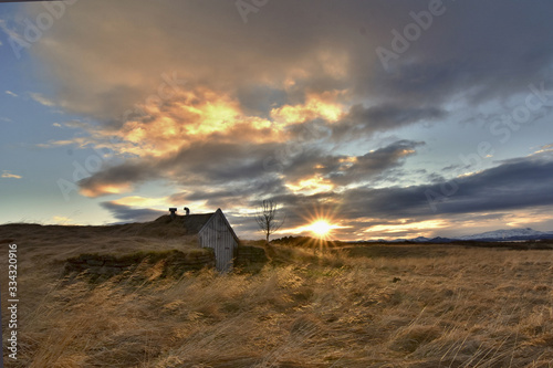 Rural and traditional turfy shelter. Romantic sunset during the winter in Iceland, Europe.