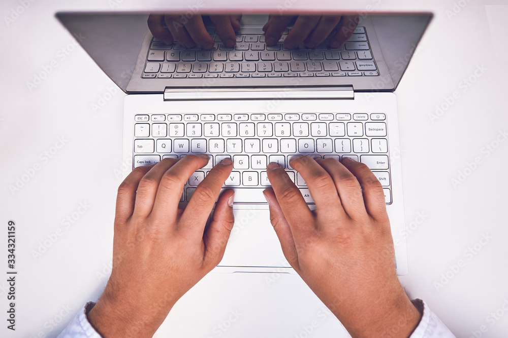 Man hand on laptop keyboard with blank screen monitor Man hand on laptop keyboard with blank screen monitor